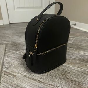 Chic Black Mini Backpack with Gold Accents